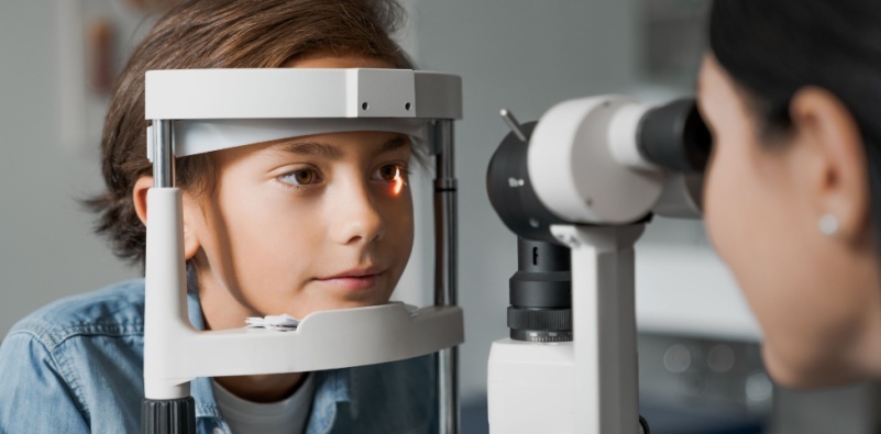 – A young boy having an eye examination at the eye doctor’s office