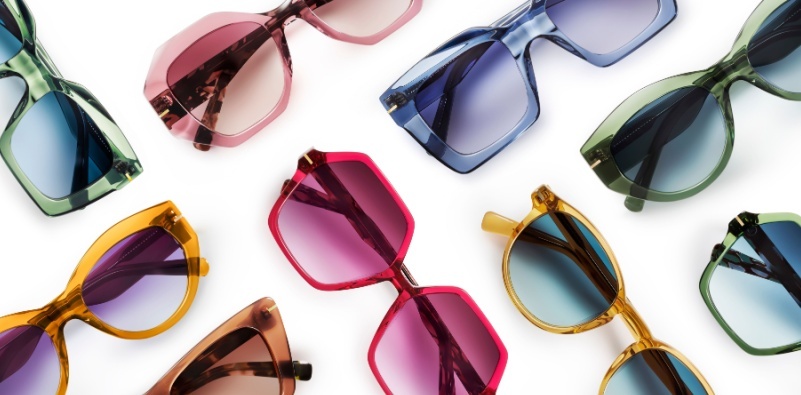 A selection of brightly colored sunglasses frames in various shapes and styles on a white background