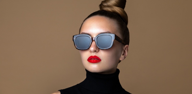 A beauty portrait of a model, wearing oversized, black, square-shaped sunglasses