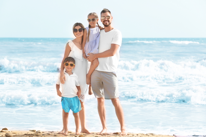 A family posing on a beach

Description automatically generated with medium confidence
