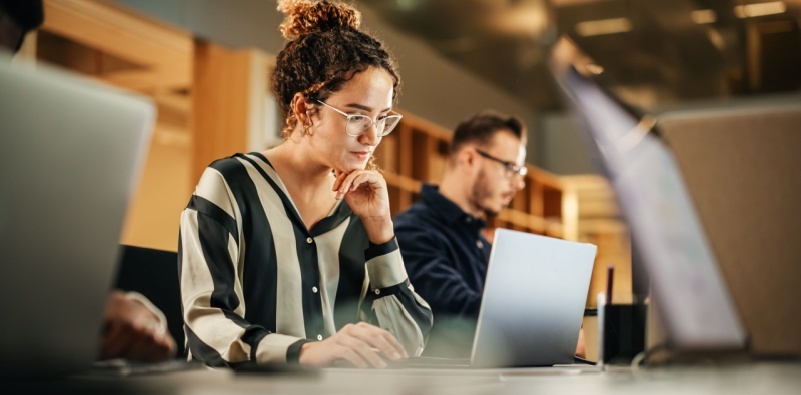 A woman looking at her laptop in the office