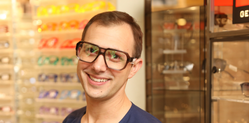 Manager Jason Davis styling a pair of pilot glasses at Davis Eyecare Associates.