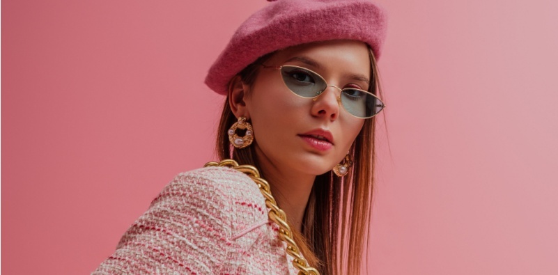 A stylish woman wearing a beret and slim cat-eye style glasses.