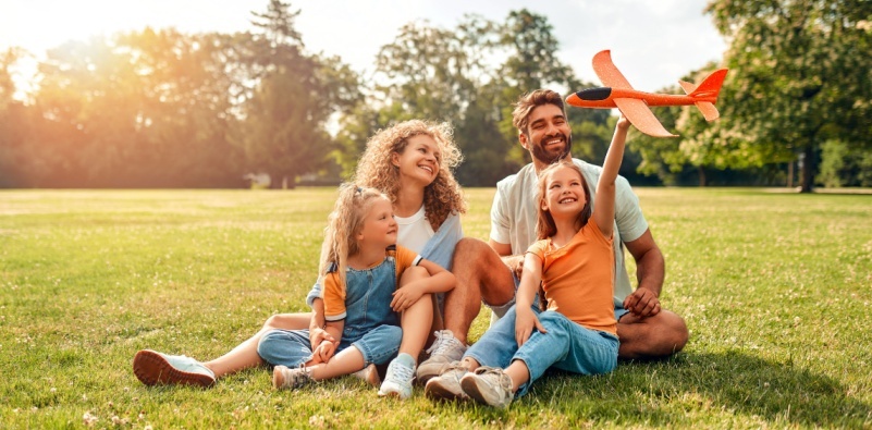 A family of four playing outside